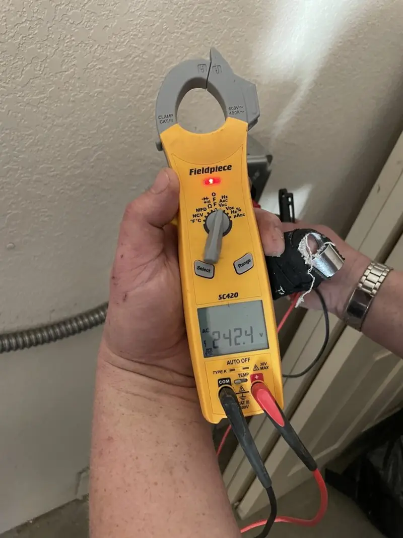 Voltage testing with clamp meter during Recessed Lighting Installation in Seymour